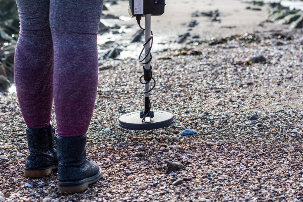 metal detecting at rocky areas of the beach