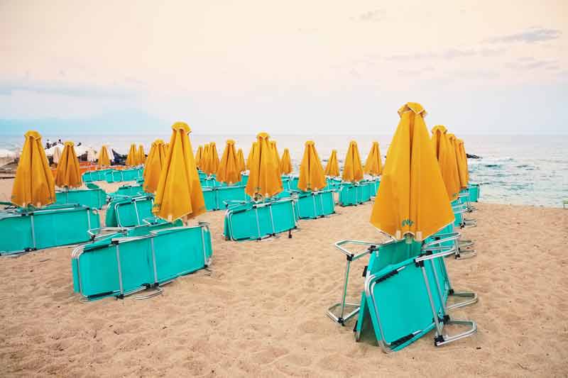 empty beach with folded chairs